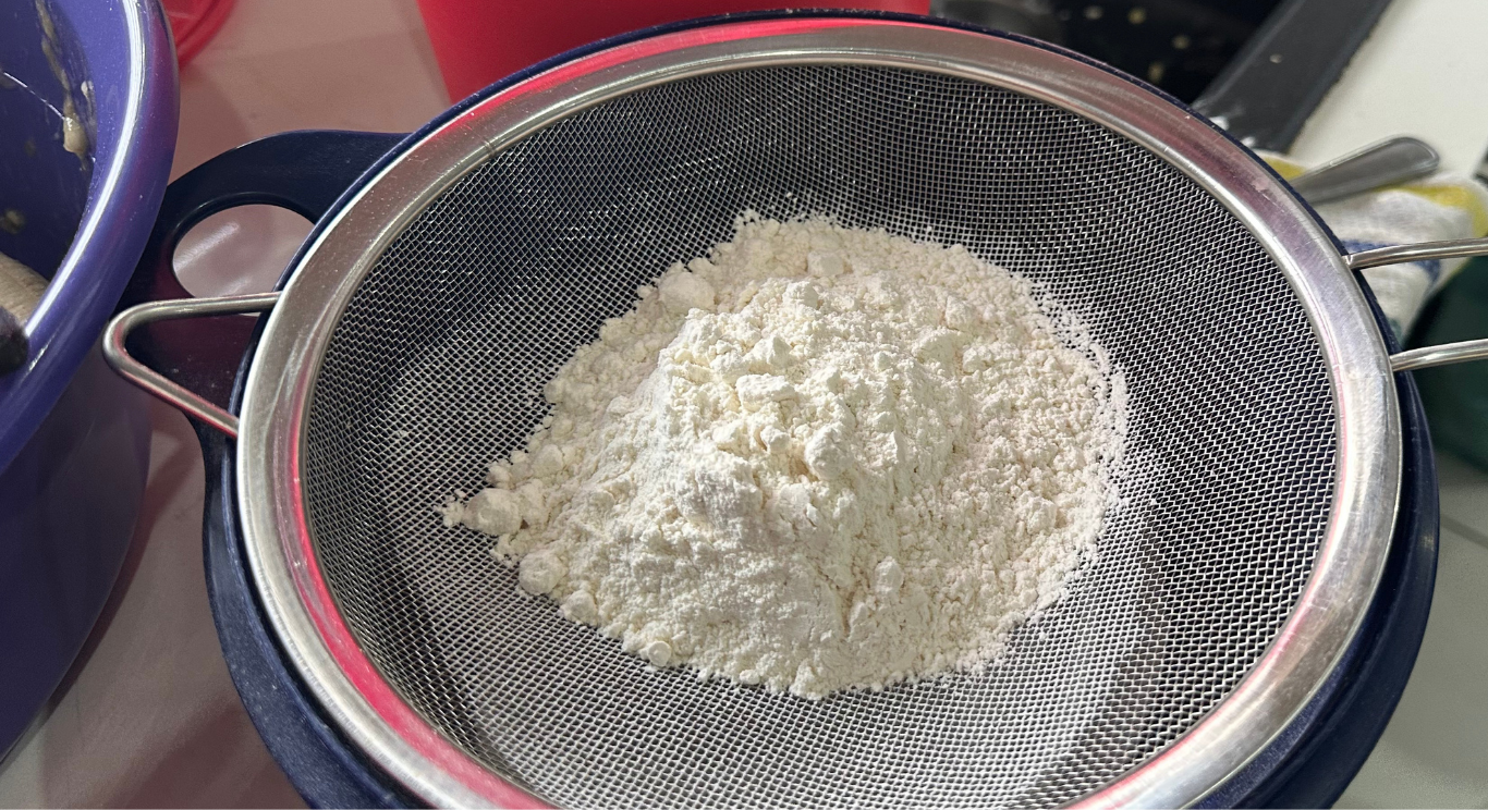 Flour being sifted for a fresh batch