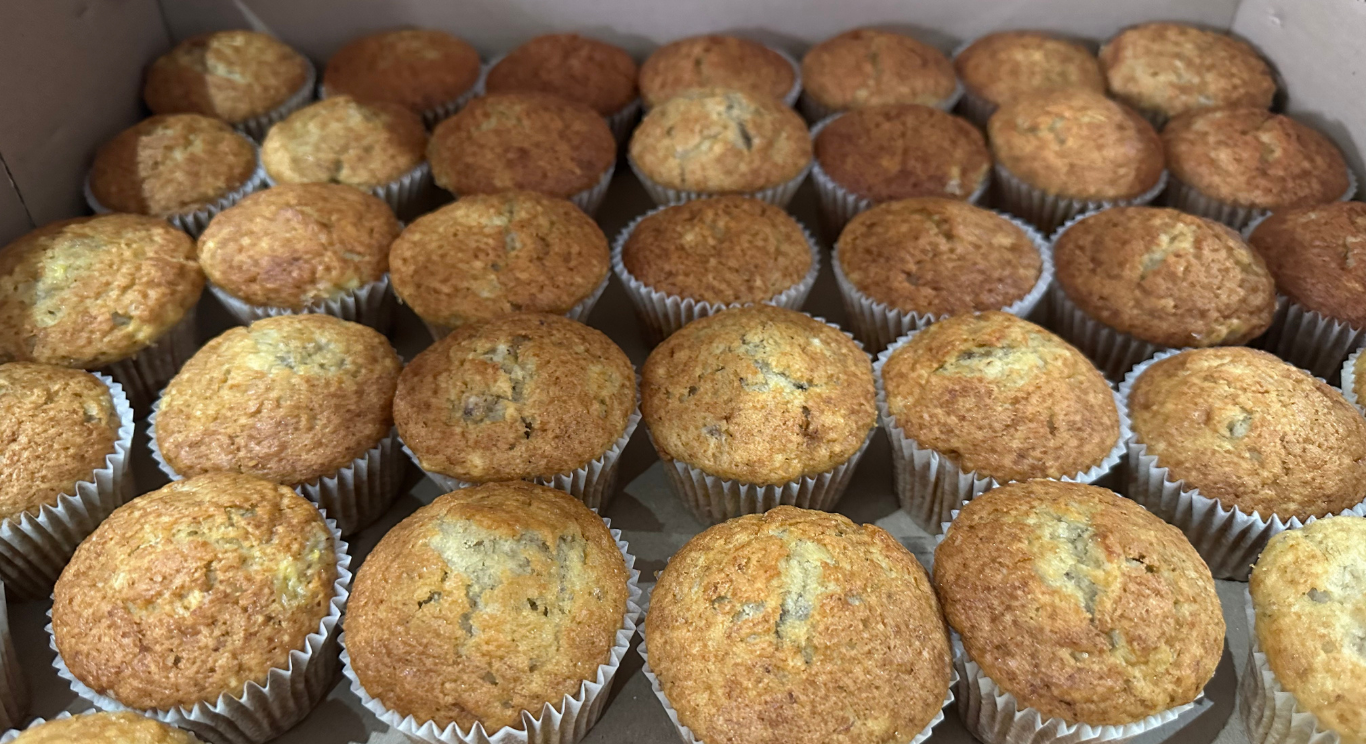 A box packed with golden, home-baked muffins