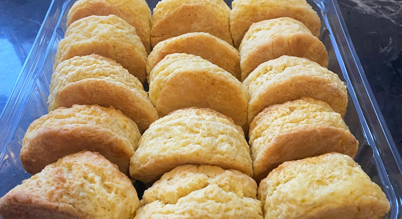 Golden scones cooling in a blue serving tray